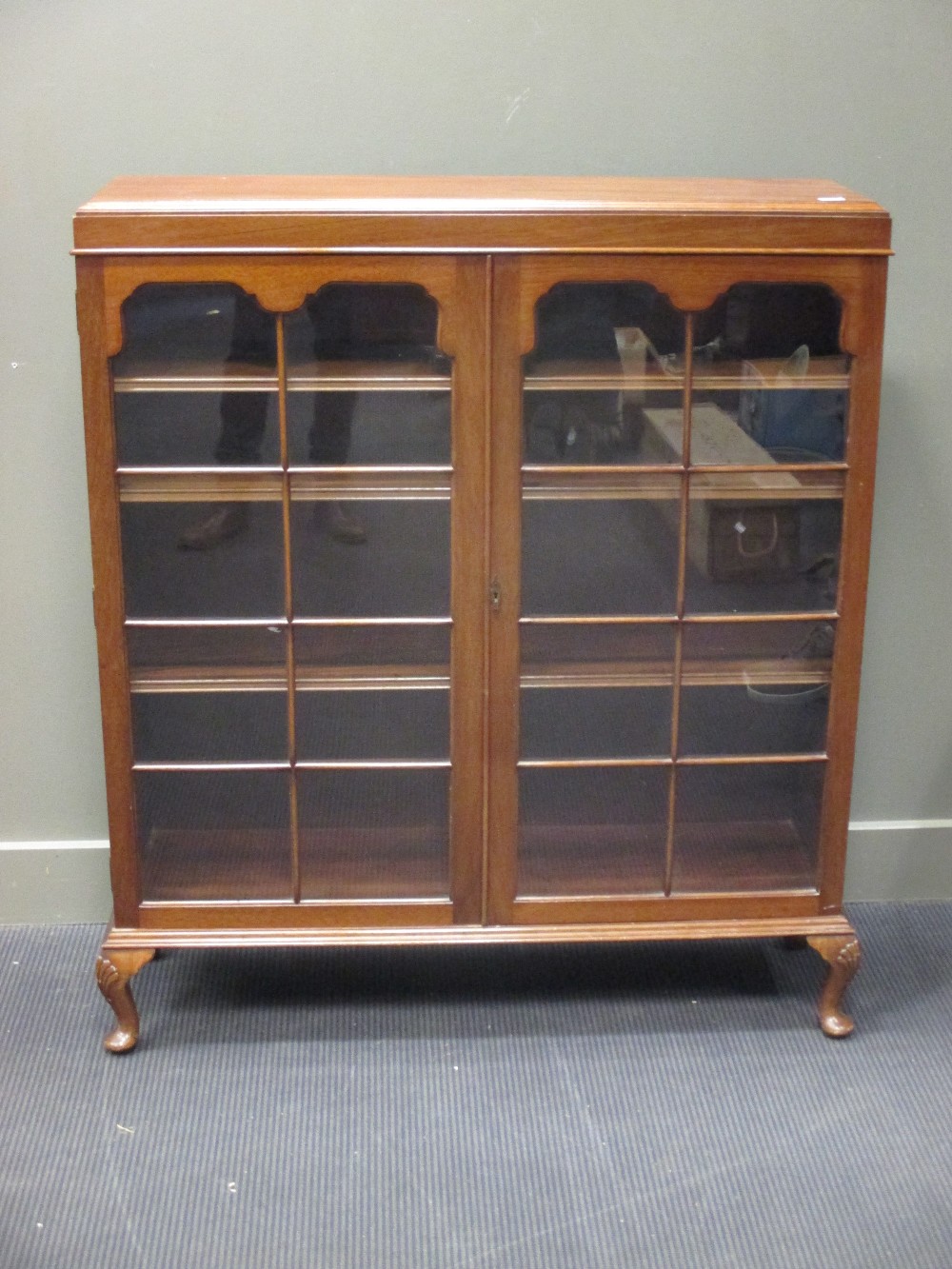 An Edwardian mahogany display cabinet on cabriole legs 108cm wide