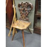 An antique carved walnut or fruitwood Continental side chair with twin figure back