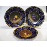 A set of five Coalport Cabinet plates, each painted with fruit and signed "F Howard", date letters