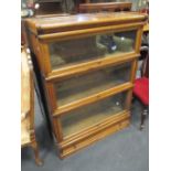 A pair of medium oak Globe Wernicke 3 section stacking bookcases with a drawer to the plinth base