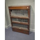 An oak Globe Wernicke style bookcase enclosed by leaded glass lift up fronts, H127cm W88cm D29cm