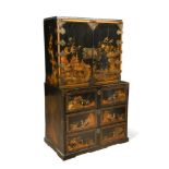 A Chinese Export gilt and black lacquer cabinet, on associated japanned chest of three drawers,