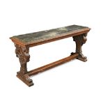 A Continental carved walnut and marble top console table, the shaped standard ends decorated with