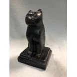 A 19th century carved wooden folk art cat, possibly Welsh, modelled seated to a stepped square