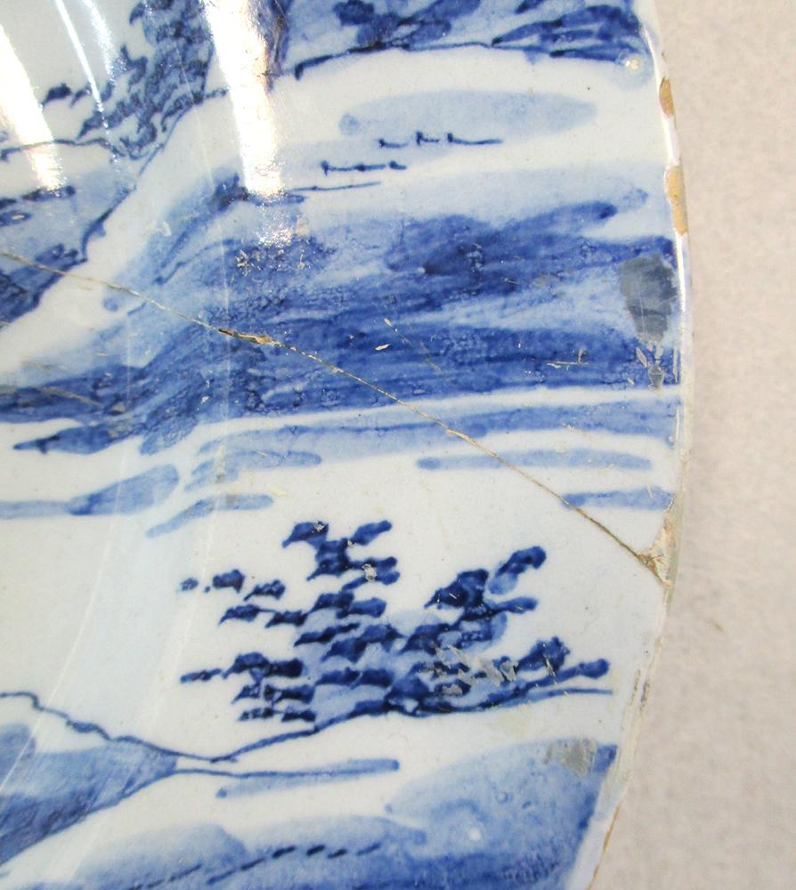 An 18th century Delft blue and white charger, decorated with a woman holding a cornucopia, 35cm - Image 8 of 13