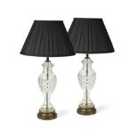 A pair of cut glass table lamps, the inverted baluster columns to gilt metal bases with black fabric