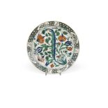 A 17th century Turkish Iznik pottery dish, Of shallow form, painted in bright enamels with red