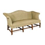 A George III camel back sofa, on four mahogany square chamfered legs, united by stretchers, on