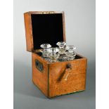 A 19th century oak decanter box and decanters, the brass bound square box opening to reveal four cut