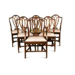 A set of seven George III ‘Hepplewhite’ dining chairs, with interlaced heart-shaped back-splats,