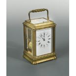 A French brass repeating carriage clock by Henri Jacot, the gorge case with rectangular enamel dial,