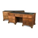A pair of late 18th century oak estate desks, with inset tops, above seven drawers around a