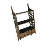 An Edwardian black and gilt lacquer hanging wall shelf, with pierced fret carved sides and two