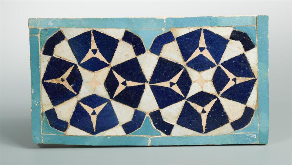 An Islamic Persian mosaic rectangular tile, with a geometric design in tones of blue and