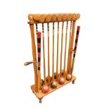 An ash Croquet stand of 8 mallets and 8 balls, with two pins, the stand with carrying handles 97 x