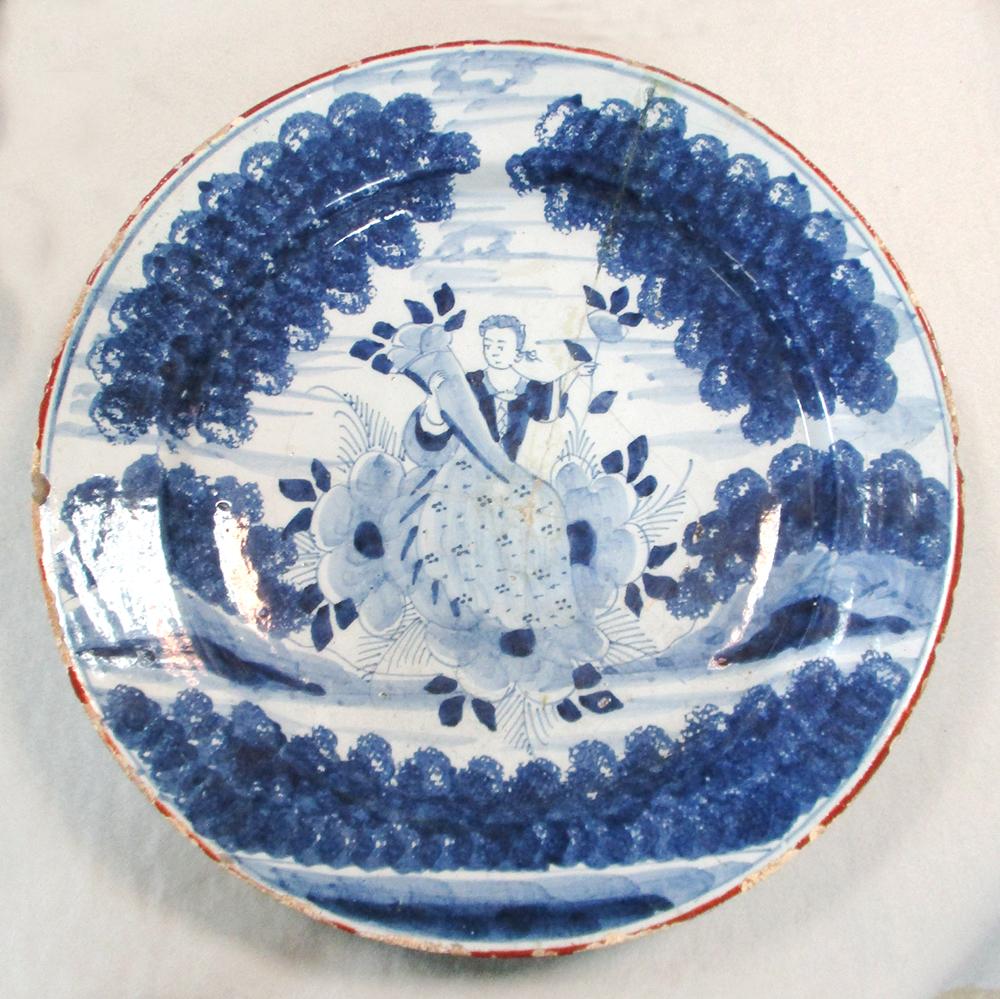 An 18th century Delft blue and white charger, decorated with a woman holding a cornucopia, 35cm - Image 2 of 13