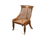 A Regency rosewood bergere library chair, on gadroon moulded legs and brass casters 81 x 56 x