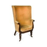 A William IV barrel back armchair, with carved show wood and scrolling arms, on turned legs and