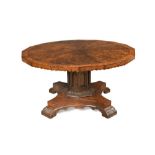 A Gothic revival figured oak pedestal centre table in the manner of Pugin, the polyagonal top with