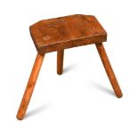 A late nineteenth/early twentieth century primitive stool, made entirely from solid yew wood