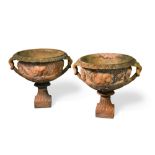 A pair of terracotta urns, of classical design, impressed with makers stamp to the base, John