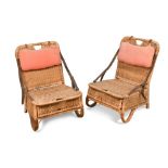 A pair of vintage wicker fishing chairs, the folding backs held by leather straps and each with a