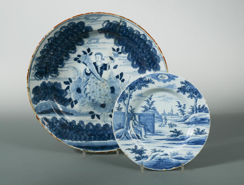 An 18th century Delft blue and white charger, decorated with a woman holding a cornucopia, 35cm