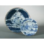 An 18th century Delft blue and white charger, decorated with a woman holding a cornucopia, 35cm