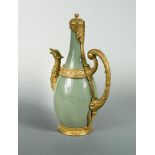 A 19th century celadon jug fitted with chased ormolu mounts, with acanthus cast hinged cover and