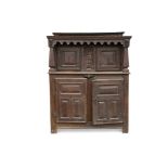 A 17th century carved oak court cupboard, the recessed upper part with arcaded frieze and bearing