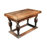 A 17th century style Flemish style oak draw leaf refectory table, with scroll edge frieze, on