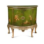 A 1920s demi-lune green japanned side cabinet, with chinoiserie decoration, on a moulded silvered