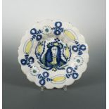 A late 17th Century Delft lobed plate, decorated in blue and yellow with a portrait of King