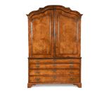 A 19th century Dutch walnut armoire, with arched figured panelled doors above four long drawers to