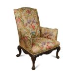 A George III style mahogany framed armchair, of large size, with C-scroll arms, upholstered in a
