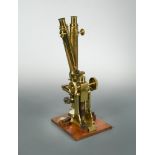 A 19th Century lacquered brass compound binocular microscope, by J. Swift, 43 University St,