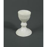A rare Saint-Cloud blanc de chine egg cup, circa 1730-50, the bowl raised on a knopped stem and