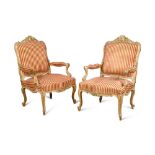 A pair of Louis XV revival carved giltwood framed armchairs, 20th century, upholstered in a