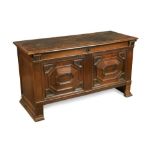 A 17th century oak coffer, with geometric moulded panelled front, plain panelled ends and on