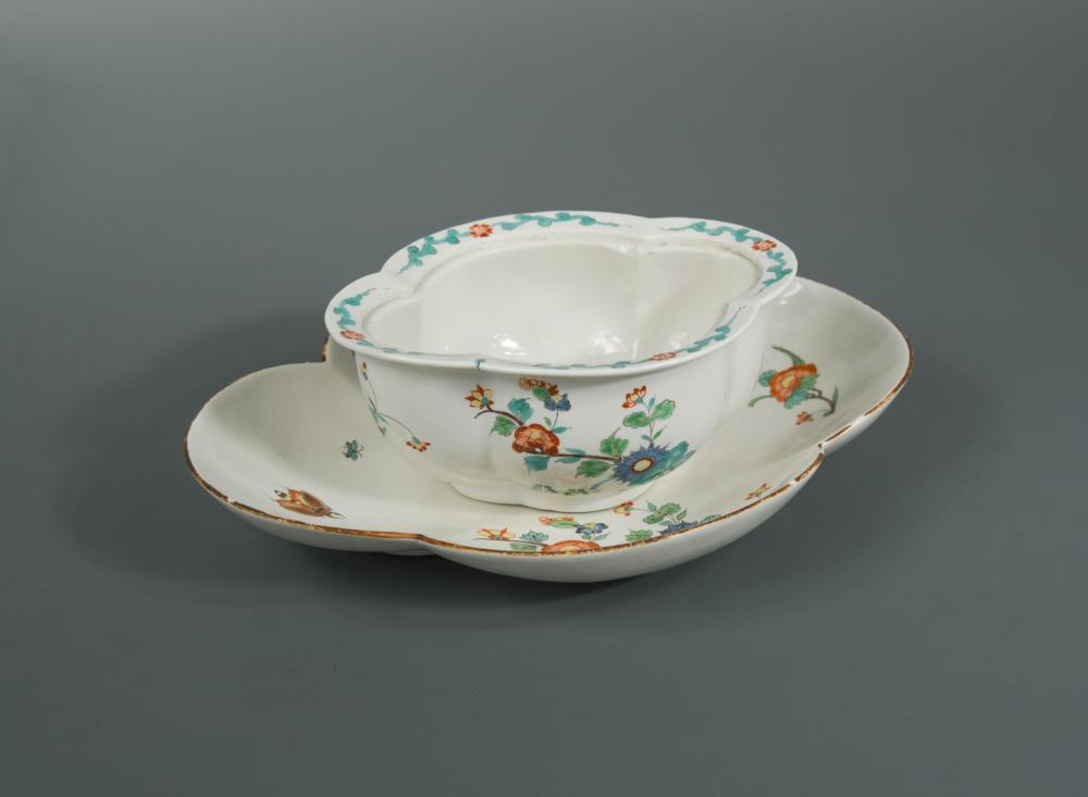A Chantilly tureen base and associated stand, circa 1735, each painted in the kakiemon style with