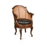 A Bergere style revolving desk chair, with green leather squab seat 97cm (38in)