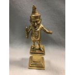 A Victorian gilt brass cigar lighter modelled as Mr Punch, modelled standing holding a quill and ink