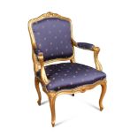 An 18th century style gilt framed salon chair, with open arms, upholstered in a royal blue woven