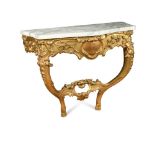 An 18th century giltwood console table, with flecked white marble, the base carved with trailing
