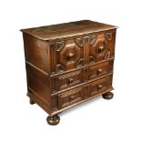 A late 17th century style oak chest of drawers, the three drawers with deep moulded fronts, on
