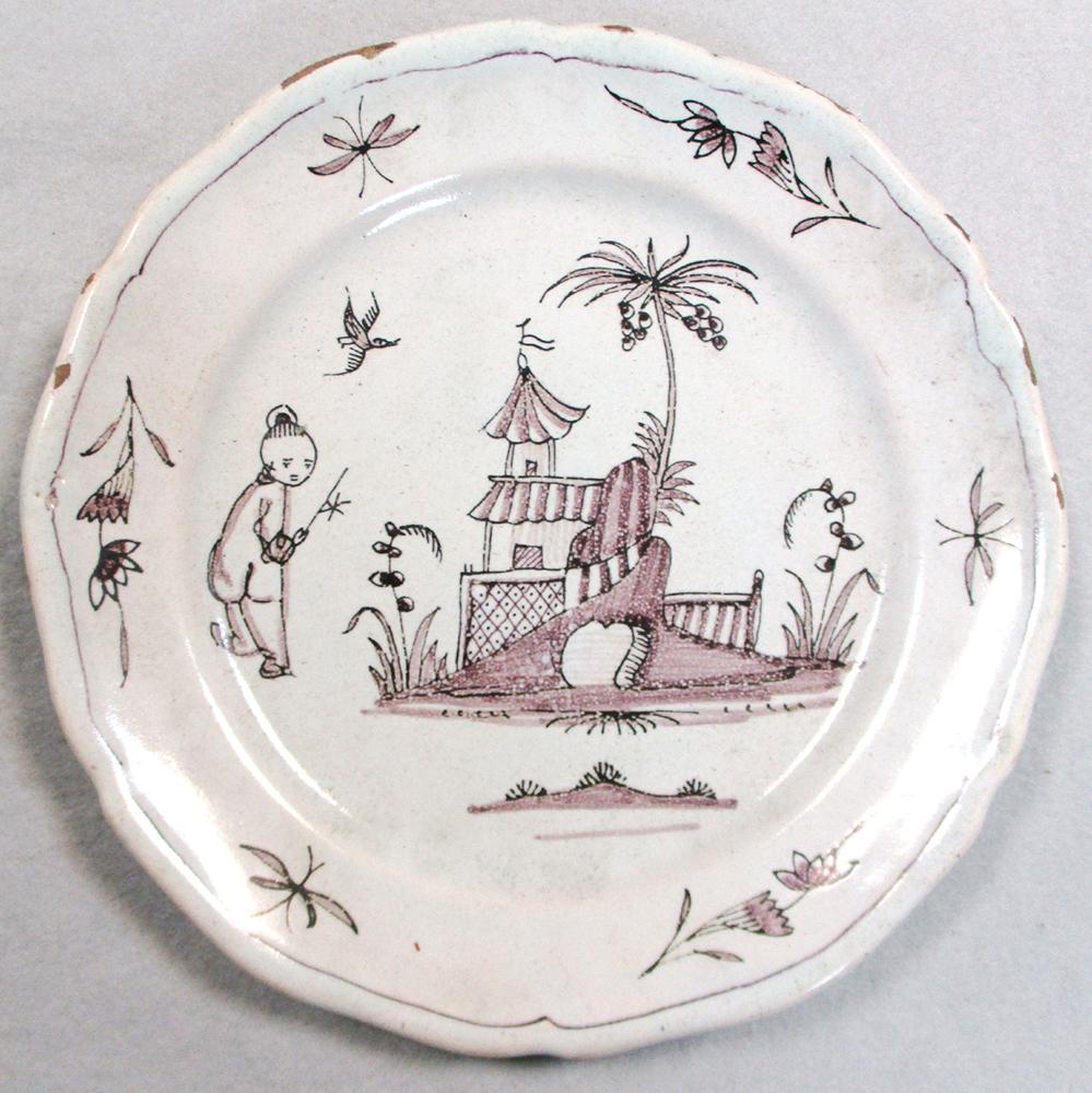 An 18th century faience plate, decorated in manganese with a house, 29cm diameter, another decorated - Image 8 of 11