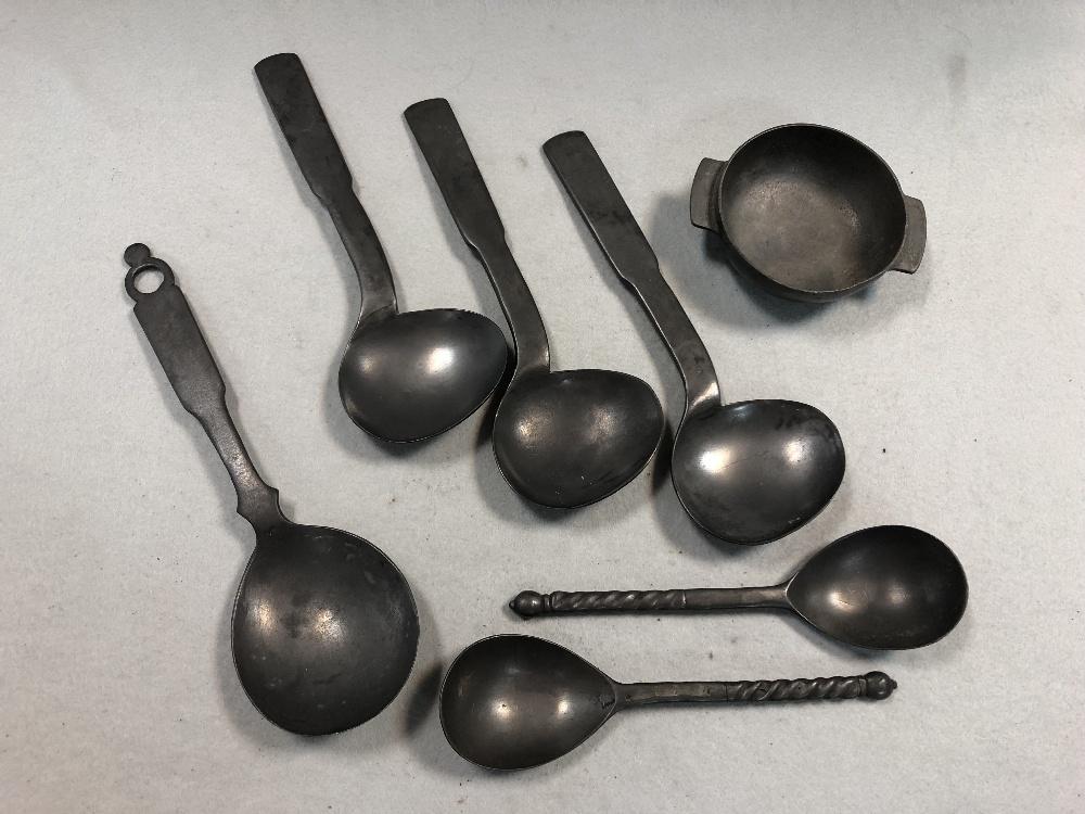 A set of three pewter shaped serving spoons,