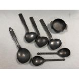 A set of three pewter shaped serving spoons,