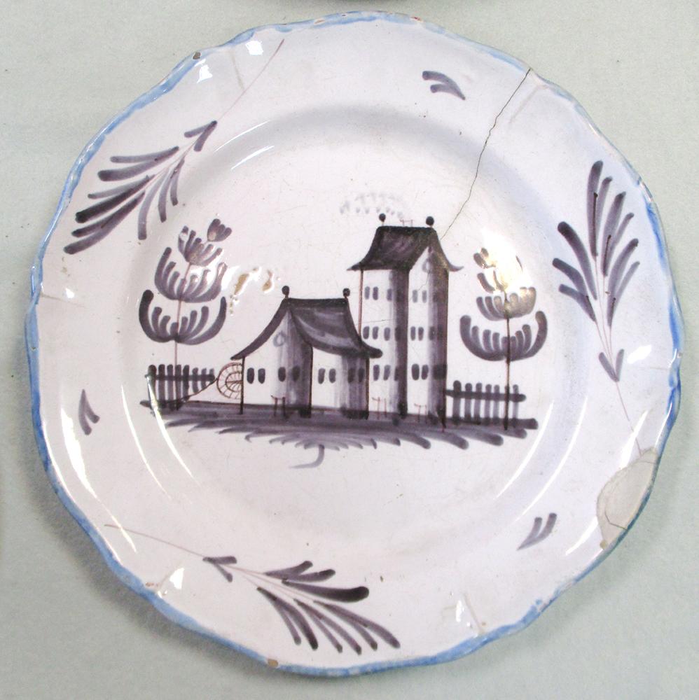 An 18th century faience plate, decorated in manganese with a house, 29cm diameter, another decorated - Image 4 of 11
