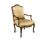 A Louis XV revival walnut open armchair, with foliate carved show wood on swept legs and leaf carved